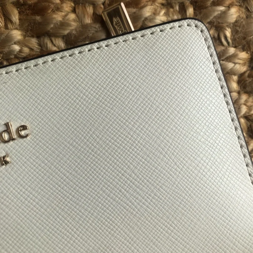 NWOT: Kate Spade Staci Slim Bifold Wallet. Saffiano Leather. Color is Parchment.